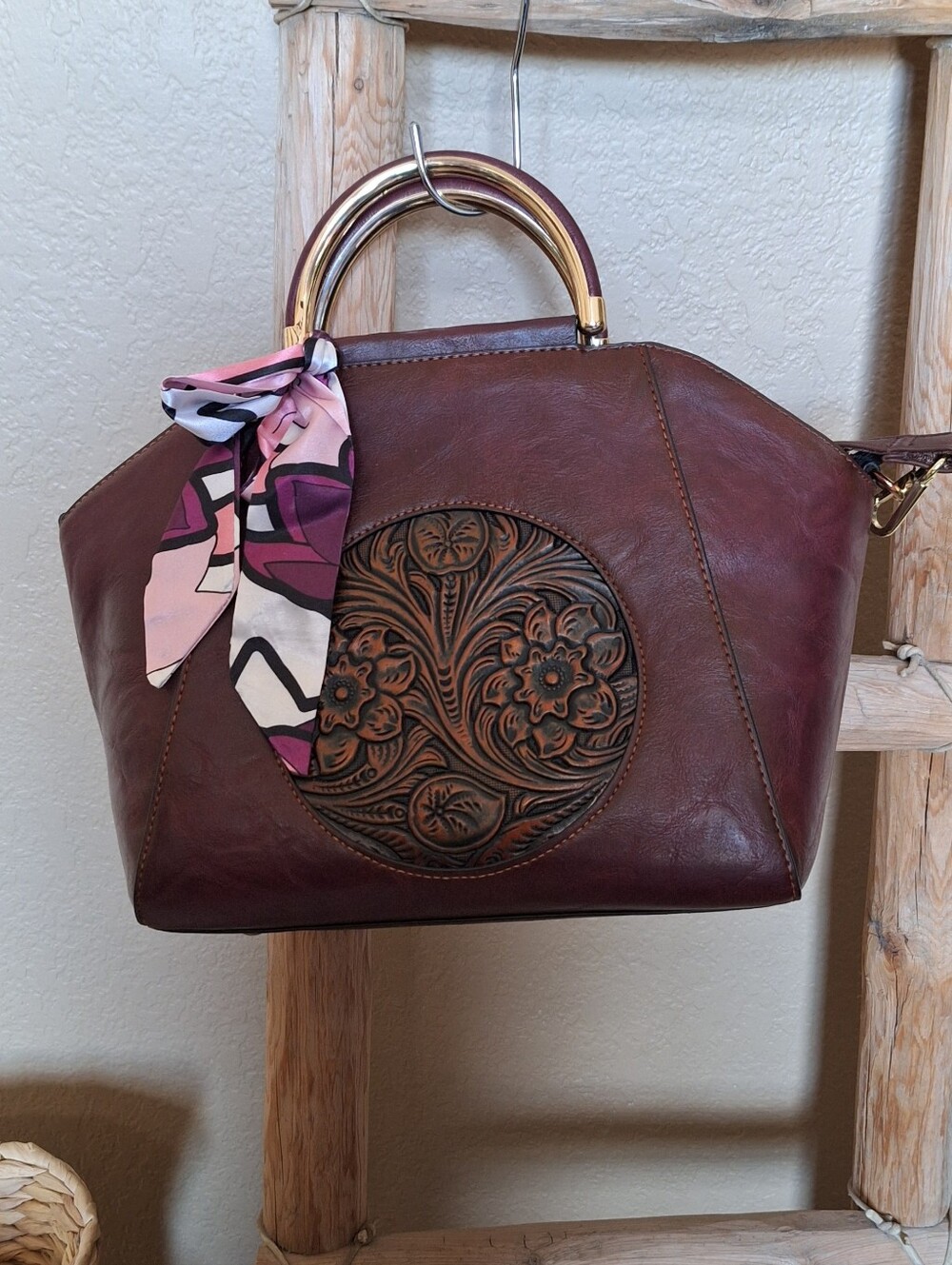 Elegant brown handbag with floral design